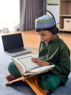 boy-sits-rug-with-laptop-quran-majeed-titled-nomad boy-sits-rug-with-laptop-quran-majeed-titled-nomad